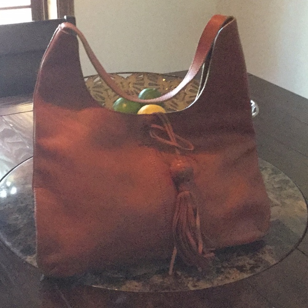 Brown leather hobo with tasseled closure